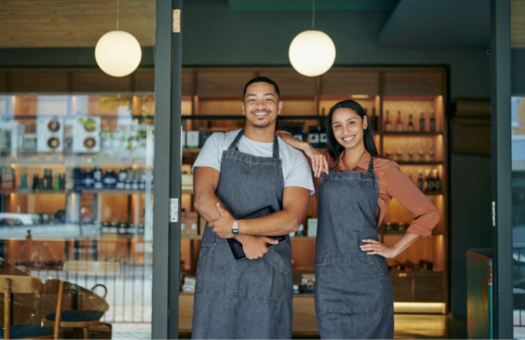 how to promote your business locally - two local business owners outside of storefront