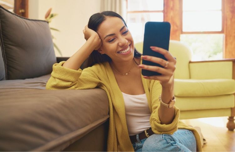 snapchat ad examples - woman looking at snapchat next to couch in yellow sweater